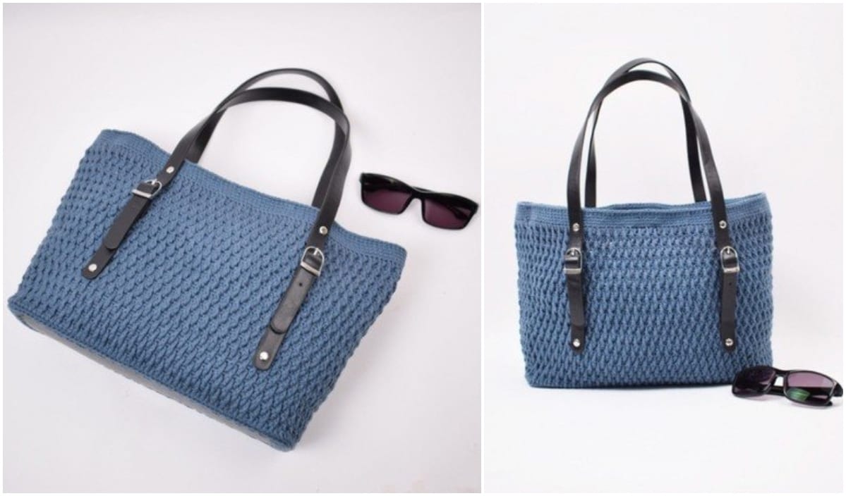 A blue woven handbag with black leather straps lies elegantly next to a pair of black sunglasses on a white background, reminiscent of chic crochet patterns.