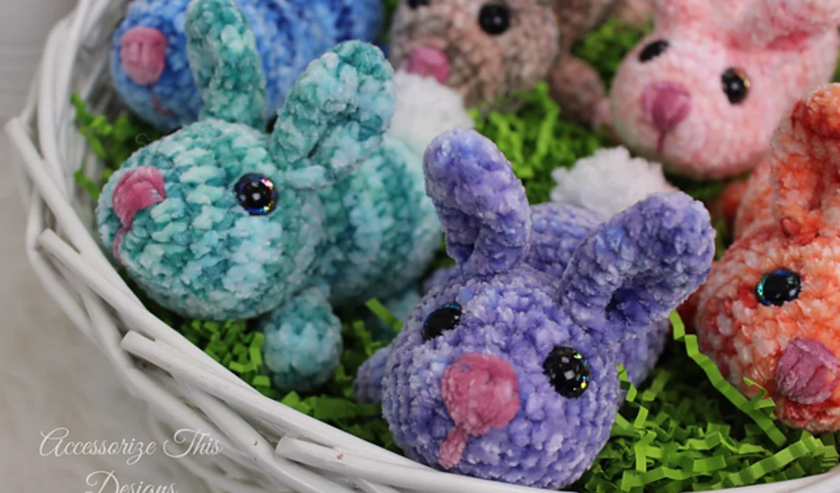 A basket filled with colorful, plush toy bunnies on green shredded paper serves as delightful Easter decorations.