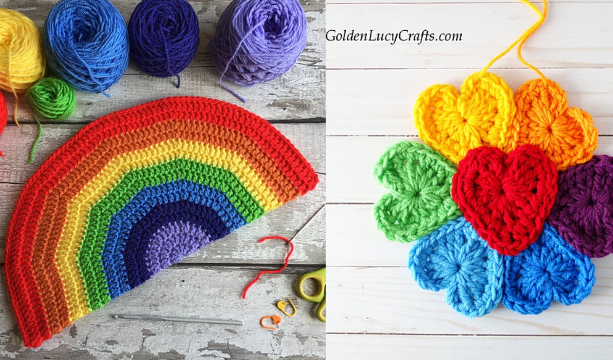 Decorative crocheted rainbow half-circle and heart-shaped motifs in various vibrant colors are artfully arranged alongside yarn balls on a wooden surface.