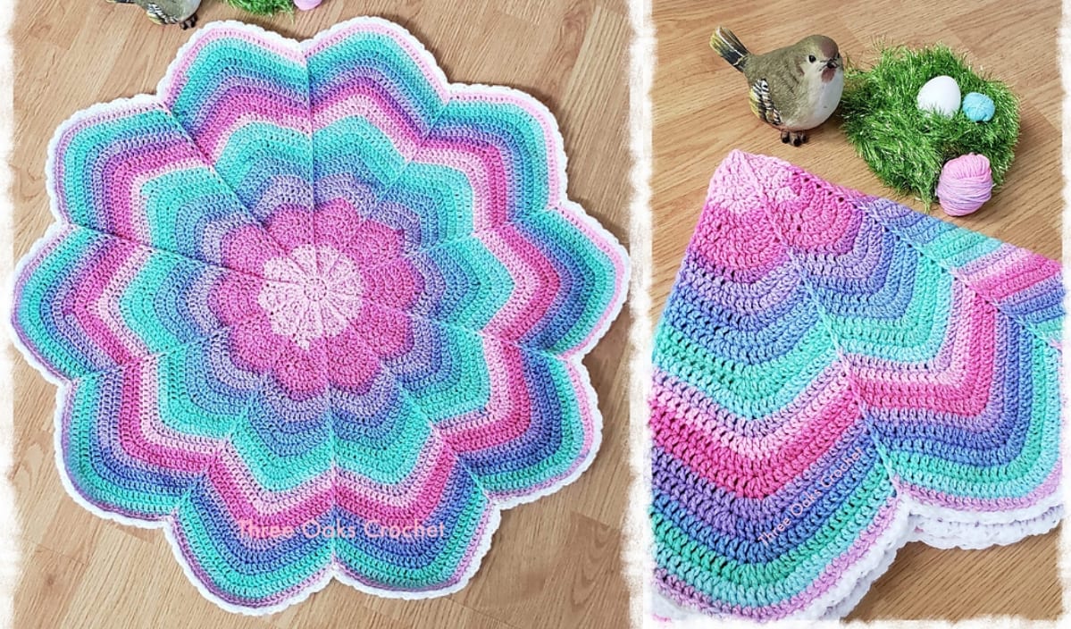 A multicolored flower-shaped crochet blanket is displayed on a wooden floor. Nearby, a small bird figurine sits beside a green nest with pink and white yarn balls, hinting at the creativity behind free crochet patterns.