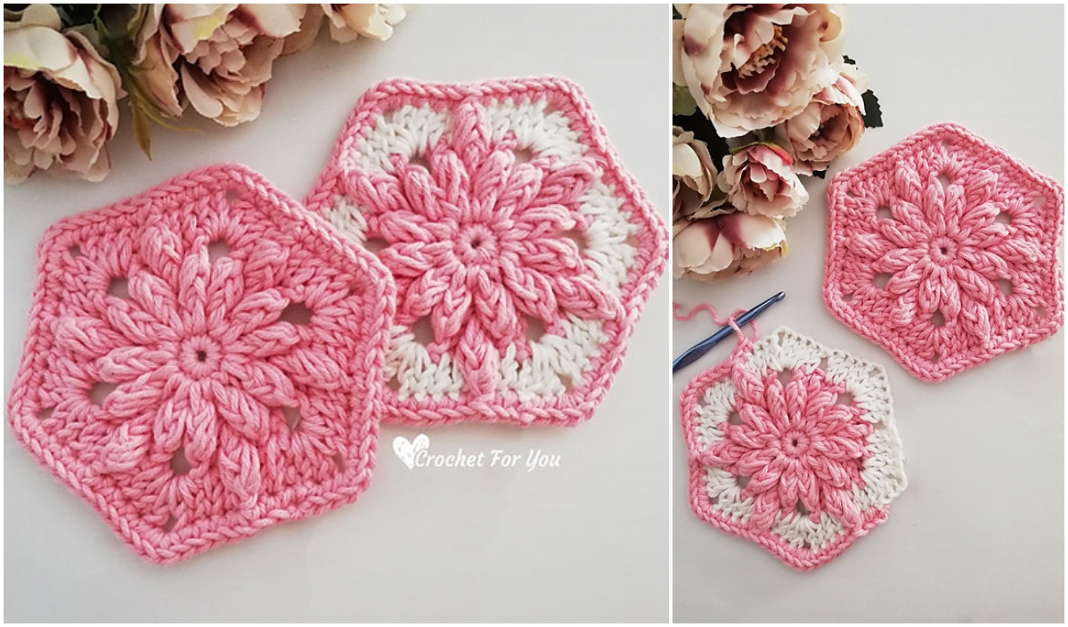 Two flowery pink and white crocheted hexagons, showcasing intricate crochet patterns, lay gracefully on a surface adorned with pink flowers, a crochet hook nearby.