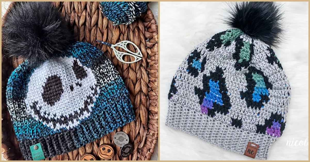 Two knit beanies: one with a blue and black design featuring a smiling face; the other in gray with blue, green, and purple animal print. Both have black faux fur pom-poms, perfect for those seeking inspiration for a new beanie crochet pattern. Scissors and buttons nearby.