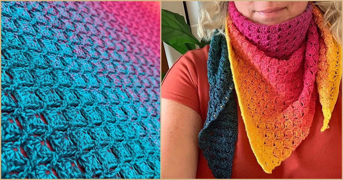 Close-up of a vibrant crochet summer shawl in blue, pink, orange, and yellow draped elegantly over an orange top.