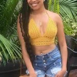 woman wearing yellow croochet crop top