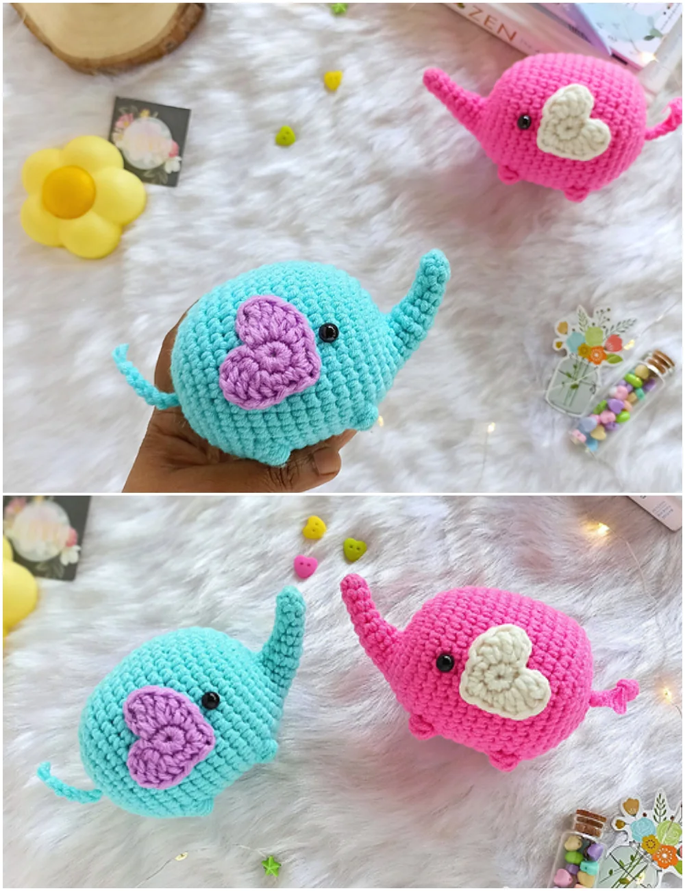 Two crochet elephants, one turquoise and one pink, each with a heart-shaped patch on its side, resting on a white faux fur surface, modeled after a popular elephant crochet pattern.