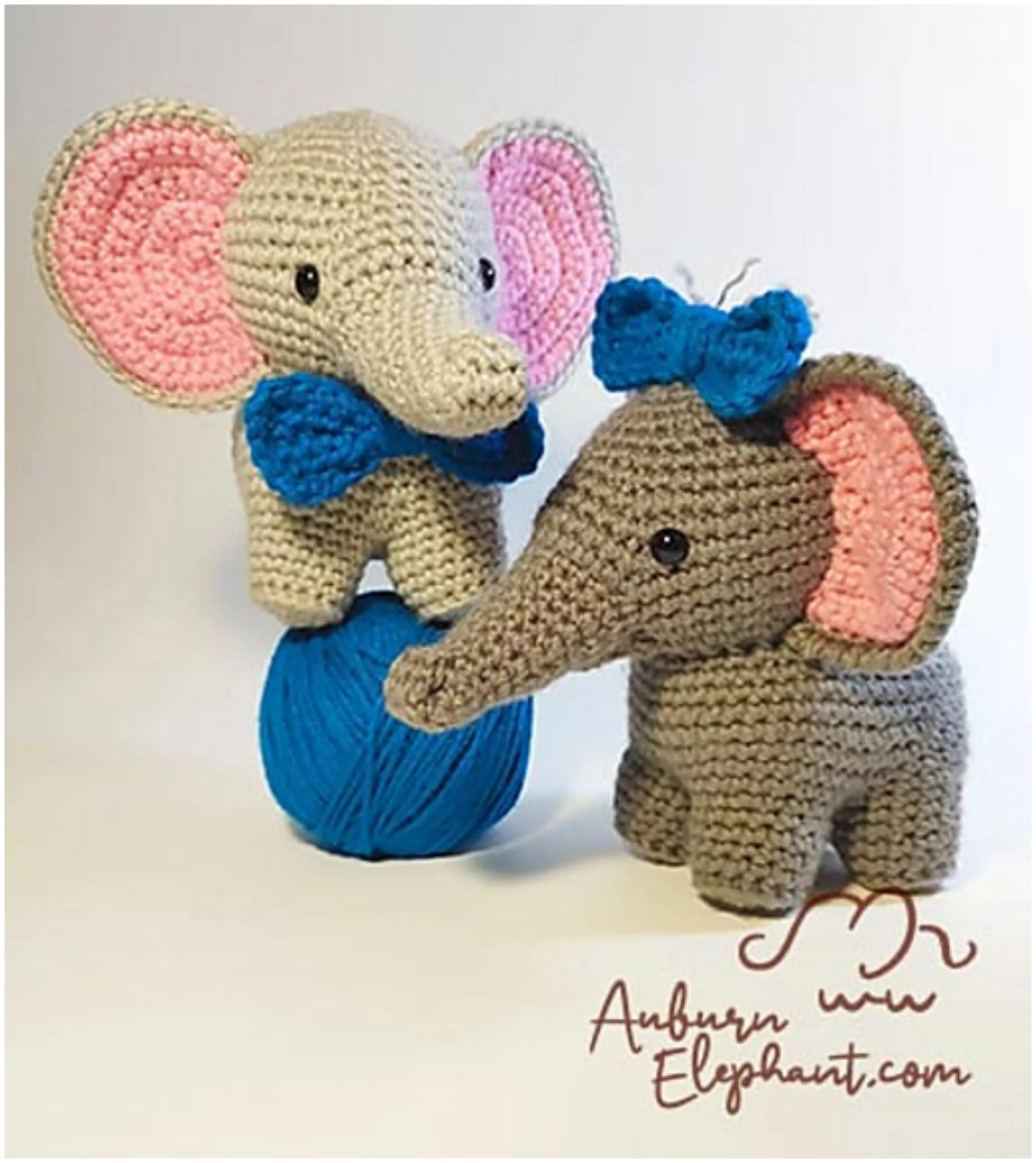 Two crocheted elephants, one standing on a ball of blue yarn and the other beside it, displayed with a logo and website address. This crochet elephant pattern includes both designs.