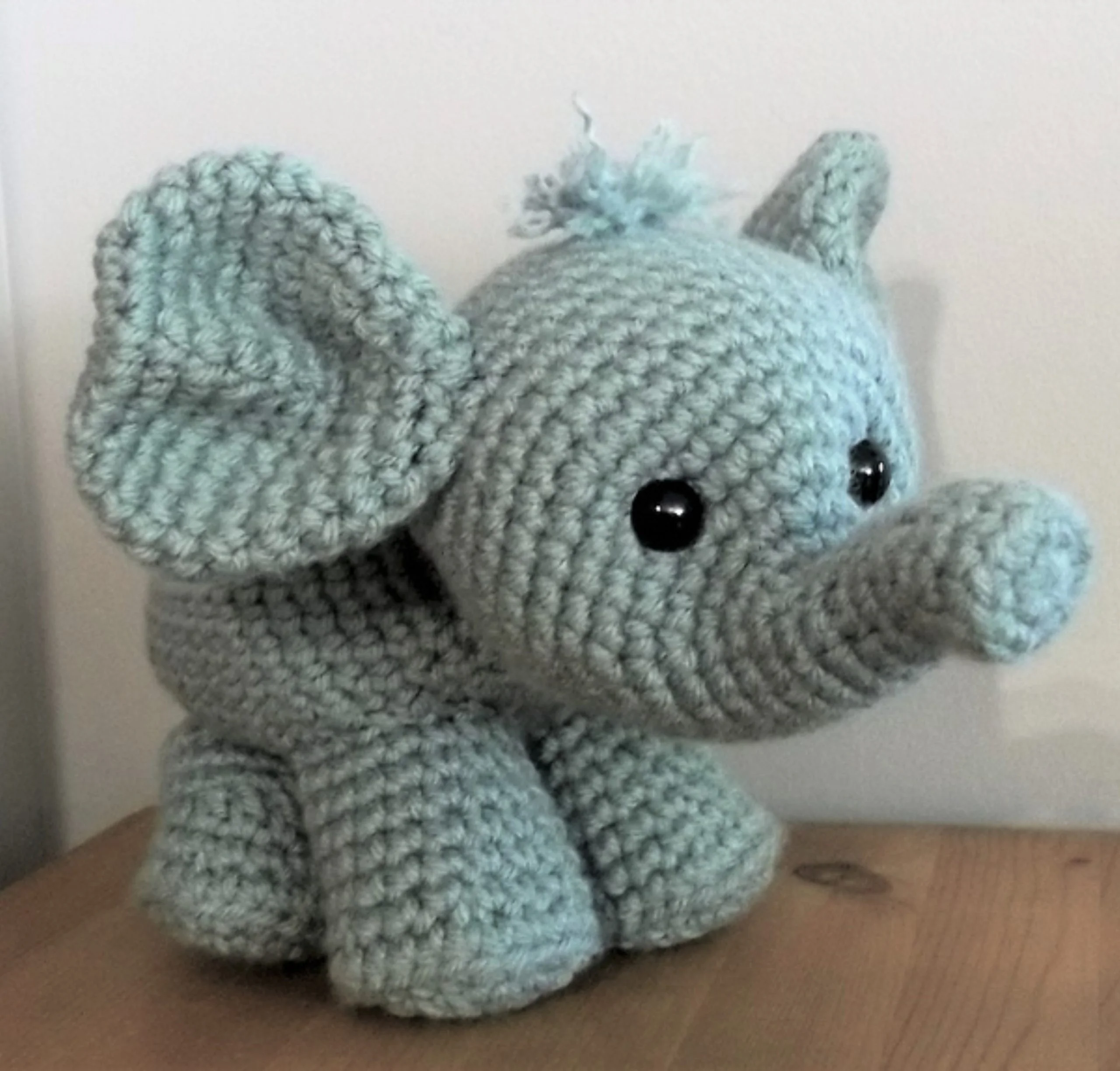 Light blue crocheted elephant stuffed animal, made using a crochet elephant pattern.