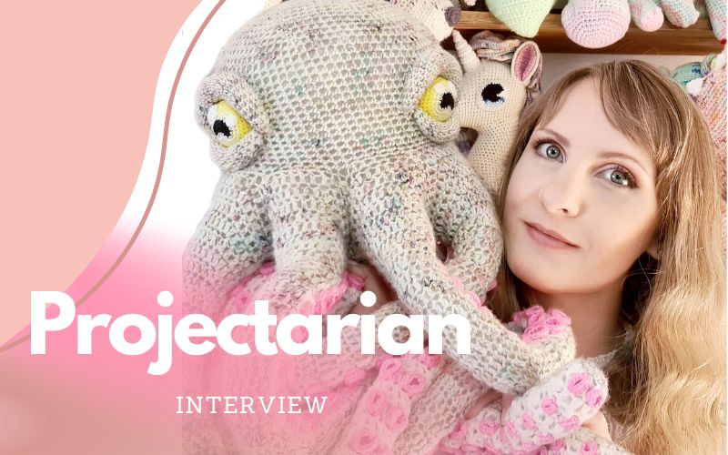 A person holds a large crocheted squid, surrounded by other charming members of the Animal Kingdom. Text overlay reads "Projectarian Interview.