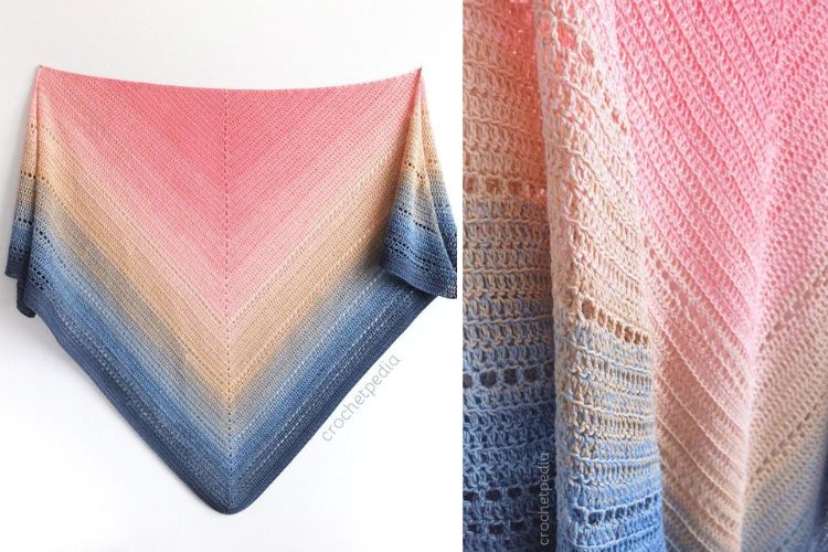 A vibrant pink and blue shawl, reminiscent of a beautiful lake sunset, gracefully hangs on a wall.