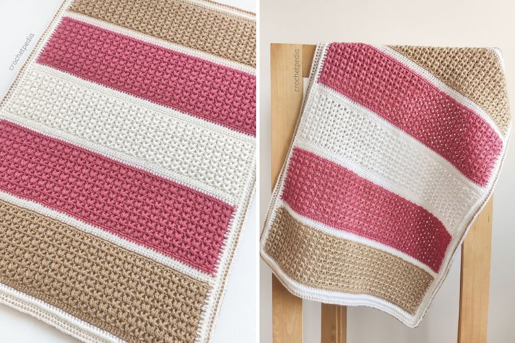 A pink and white crocheted afghan on a wooden chair, perfect for a lake sunset shawl.