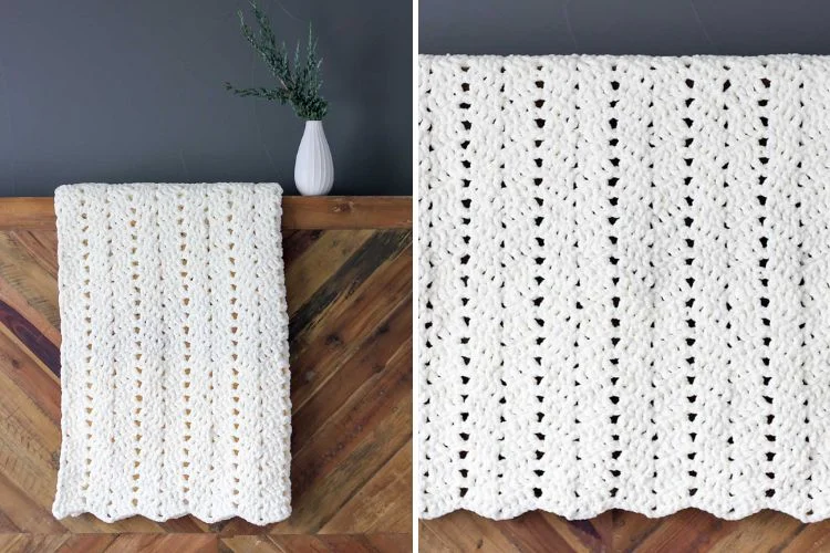 The Snow Drifter Chunky Blanket, a white crocheted afghan, hanging on a wooden wall.