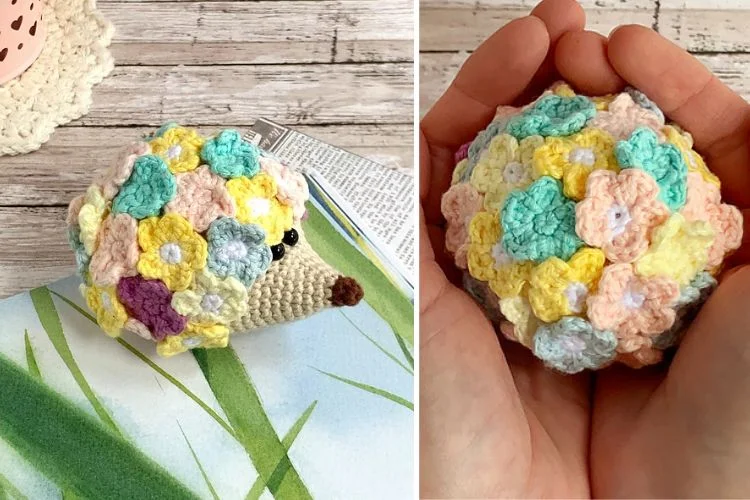 A hand holding a crocheted hedge with flowers on it.