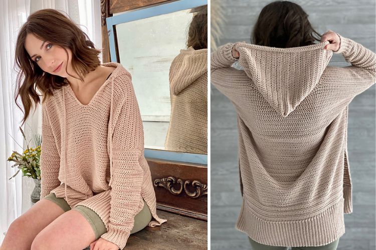 A woman is wearing a beige sweater with a hood.