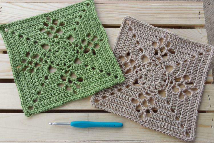 Two crocheted squares on a wooden table.