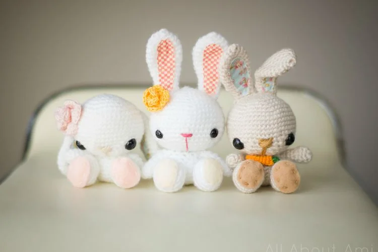 Spring Bunnies: Three crocheted bunnies sitting on a chair.