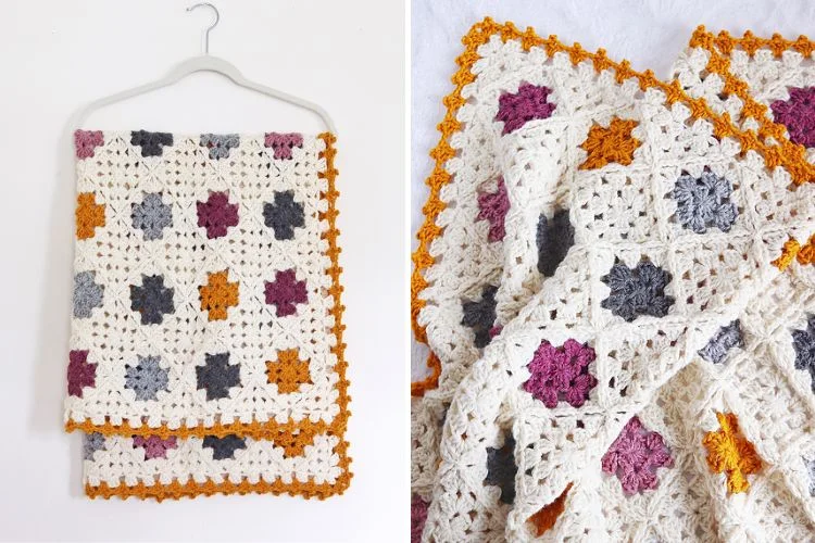 A crocheted afghan hanging on a hanger.