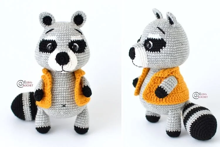 A crocheted raccoon wearing an orange vest.