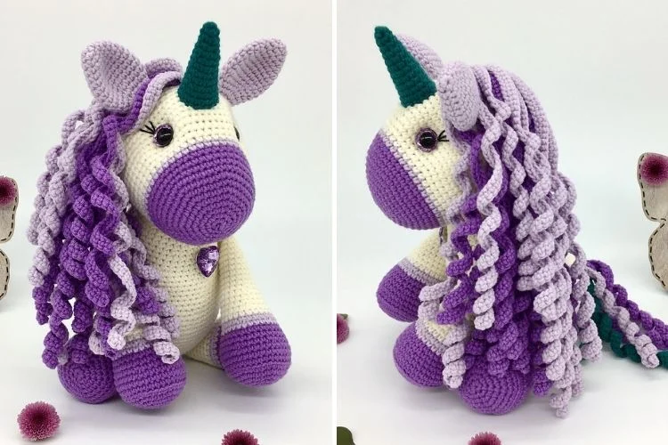 A crocheted unicorn with purple and white hair.