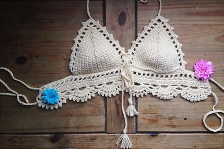 A crocheted bikini with flowers on it.