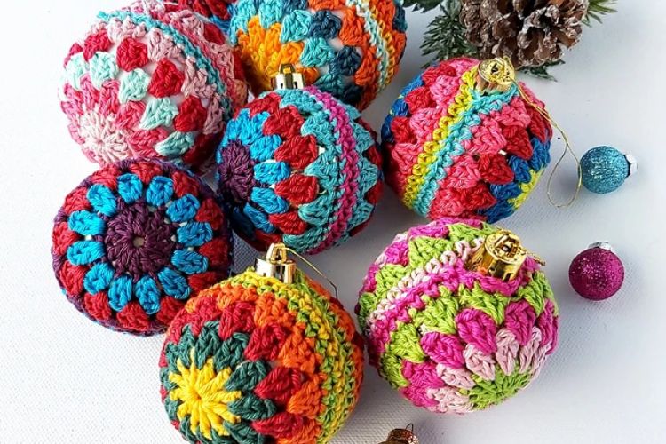 Crocheted christmas ornaments on a white table.