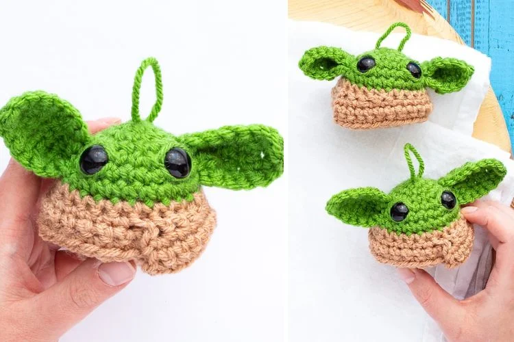 a crochet baby yoda amigurumi designed as an ornament with a hanging string