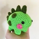 a green crochet dinosaur