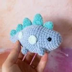 a blue crochet dinosaur amigurumi