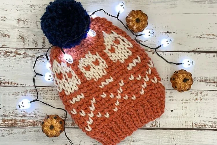 An orange knitted hat with lights on it.