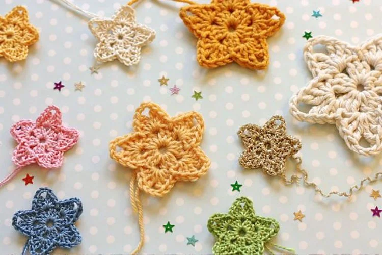 Crocheted star ornaments on a polka dot background.