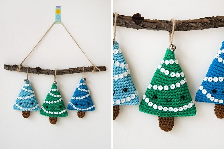 Three crocheted christmas trees hanging from a branch.