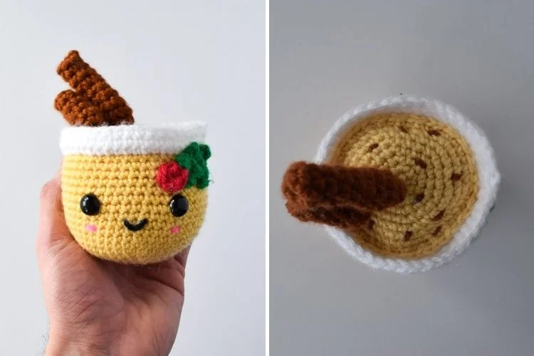 A crocheted mug with a cinnamon stick in it.