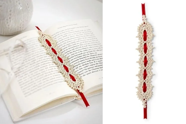 A red and white crochet bookmark on an open book.