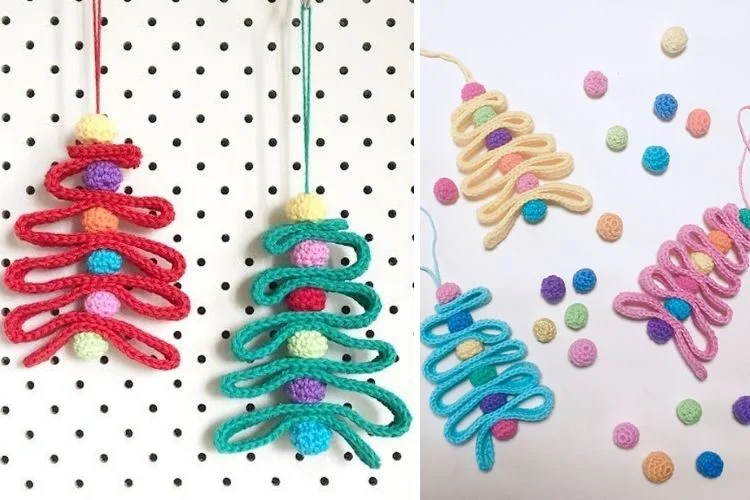 Crocheted christmas tree ornaments hanging on a wall.