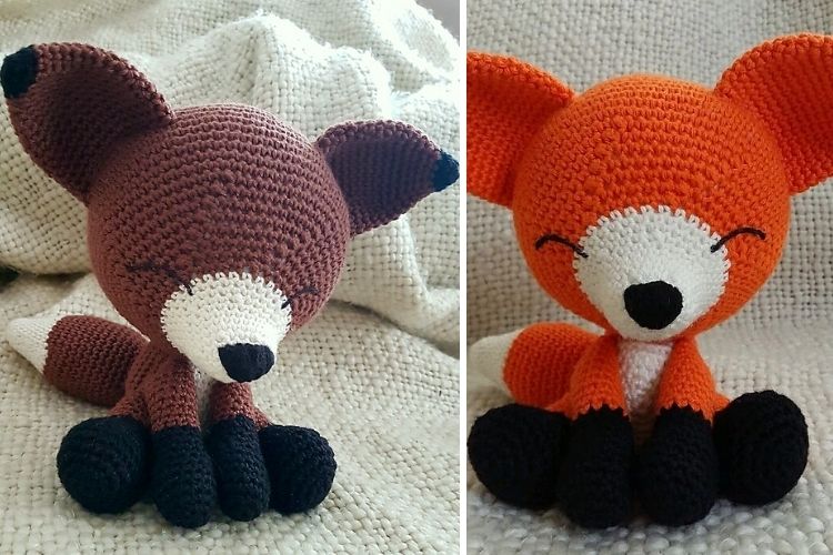 Two crocheted foxes sitting next to each other.