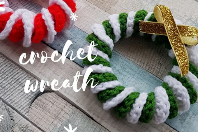 Two crochet wreaths on a wooden table.