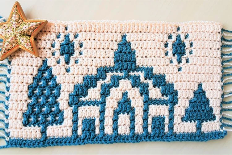 A crocheted blanket with a star on it.