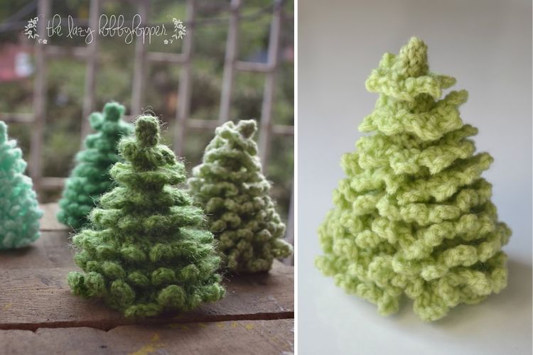 Crocheted Christmas trees on a wooden table, decorated for the festive season.