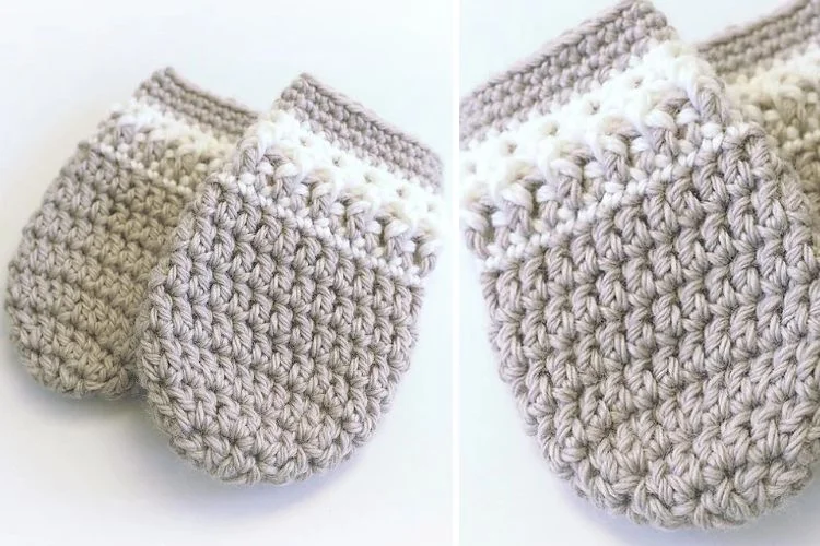 A pair of crocheted mittens on a white surface.