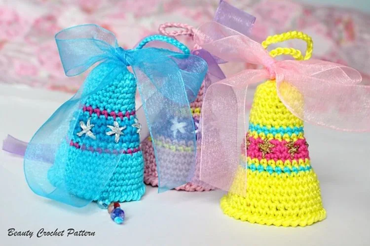 Three crocheted hats with bows and ribbons.