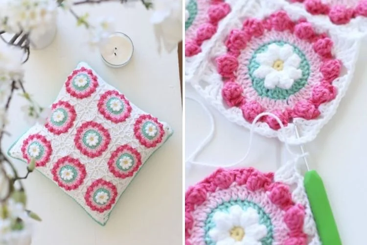 A crocheted pillow with flowers and a crochet hook.