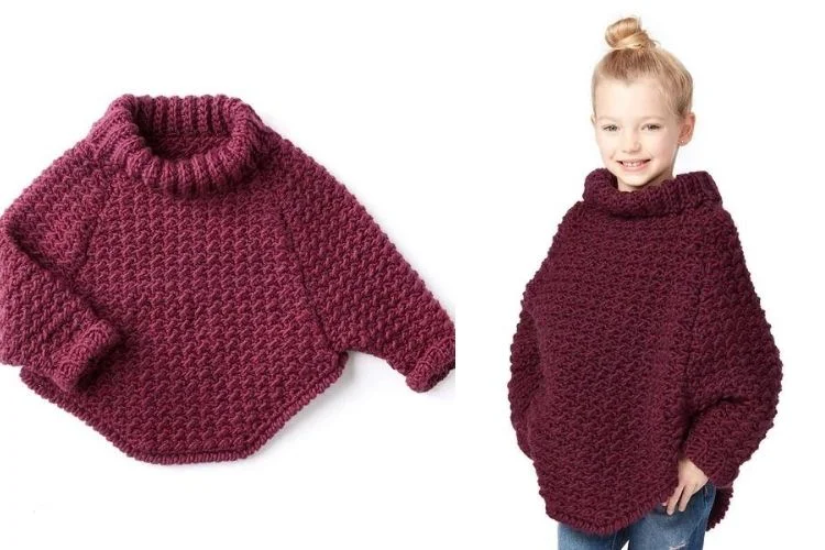 A little girl wearing a burgundy knitted sweater.