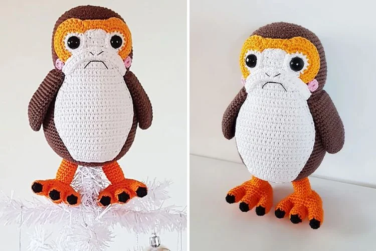 A crocheted penguin sitting on top of a christmas tree.