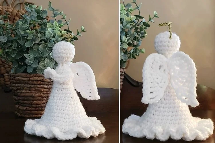 A crocheted angel ornament on a table next to a potted plant.