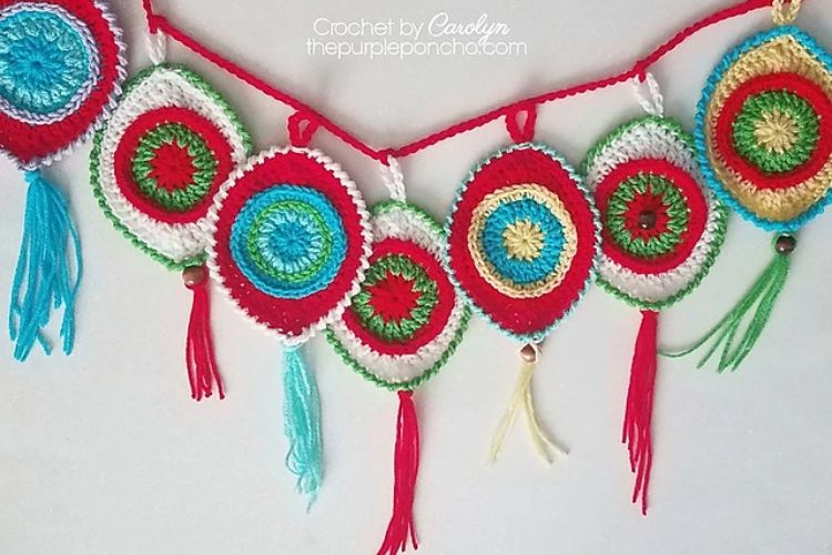 Crocheted christmas garland with colorful tassels.