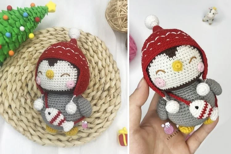 A crocheted penguin wearing a red hat.