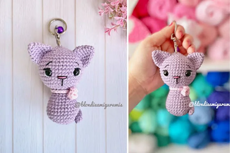 A crocheted cat keychain with a pink bow.