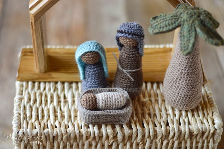 A crocheted nativity scene on a wicker basket.