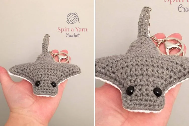 A crocheted shark with a key ring attached to it.