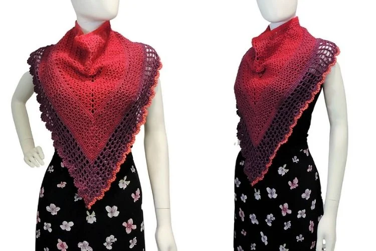 Two mannequins wearing red and pink shawls.