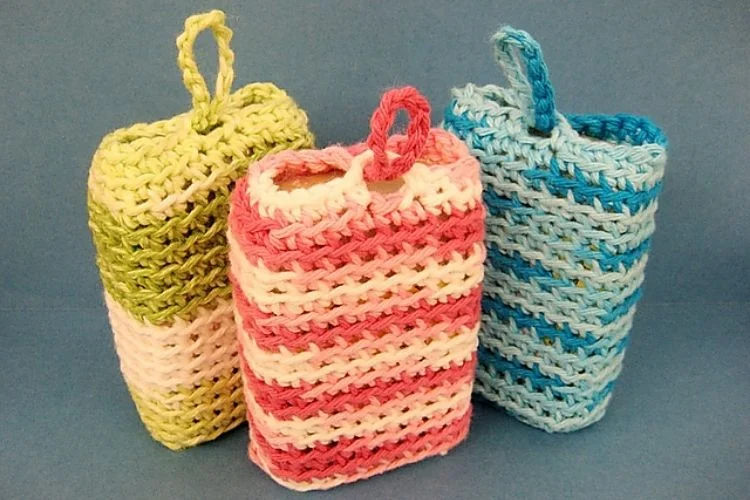 Three crocheted cell phone holders on a blue background.